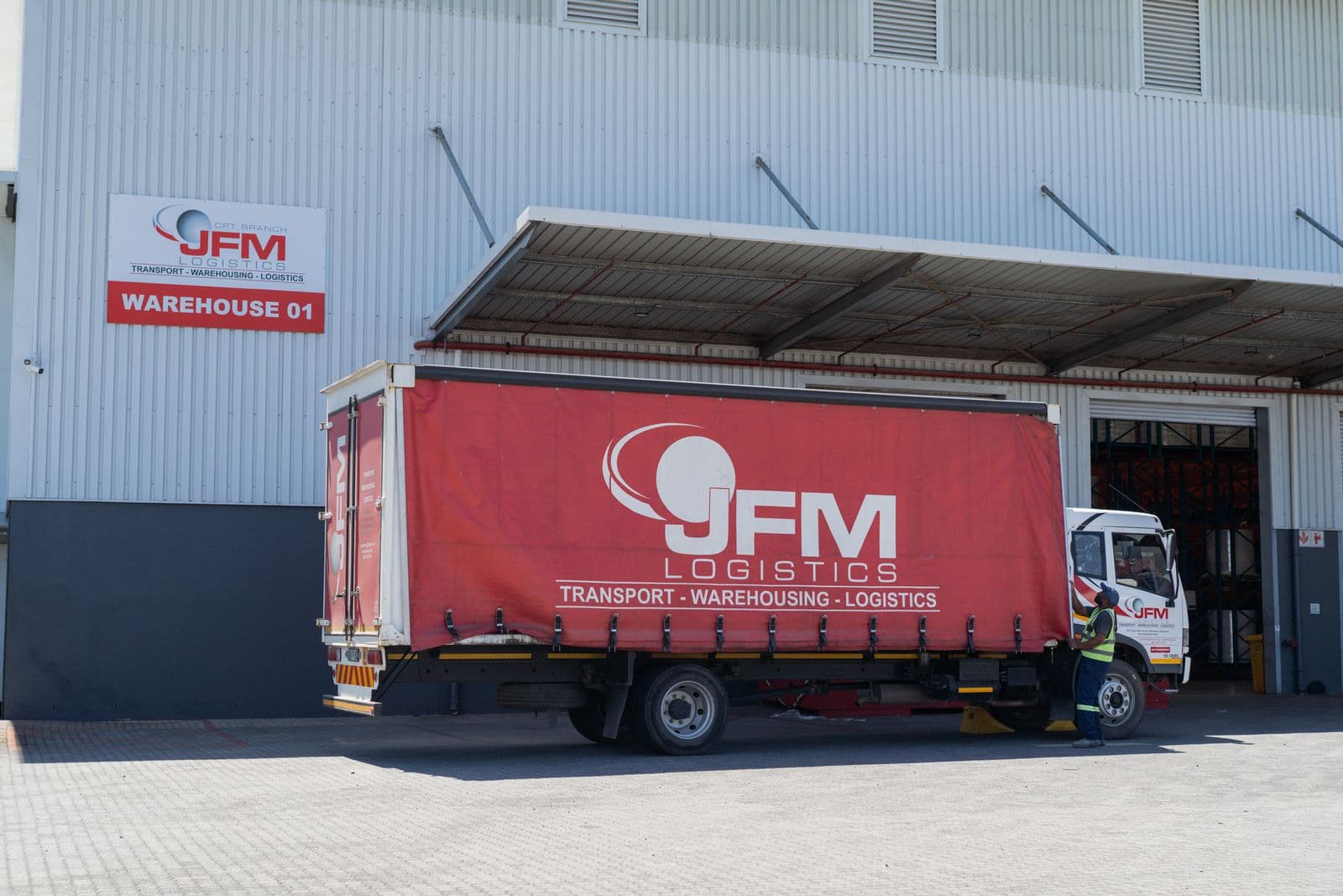 JFM curtain-side truck at Warehouse 01